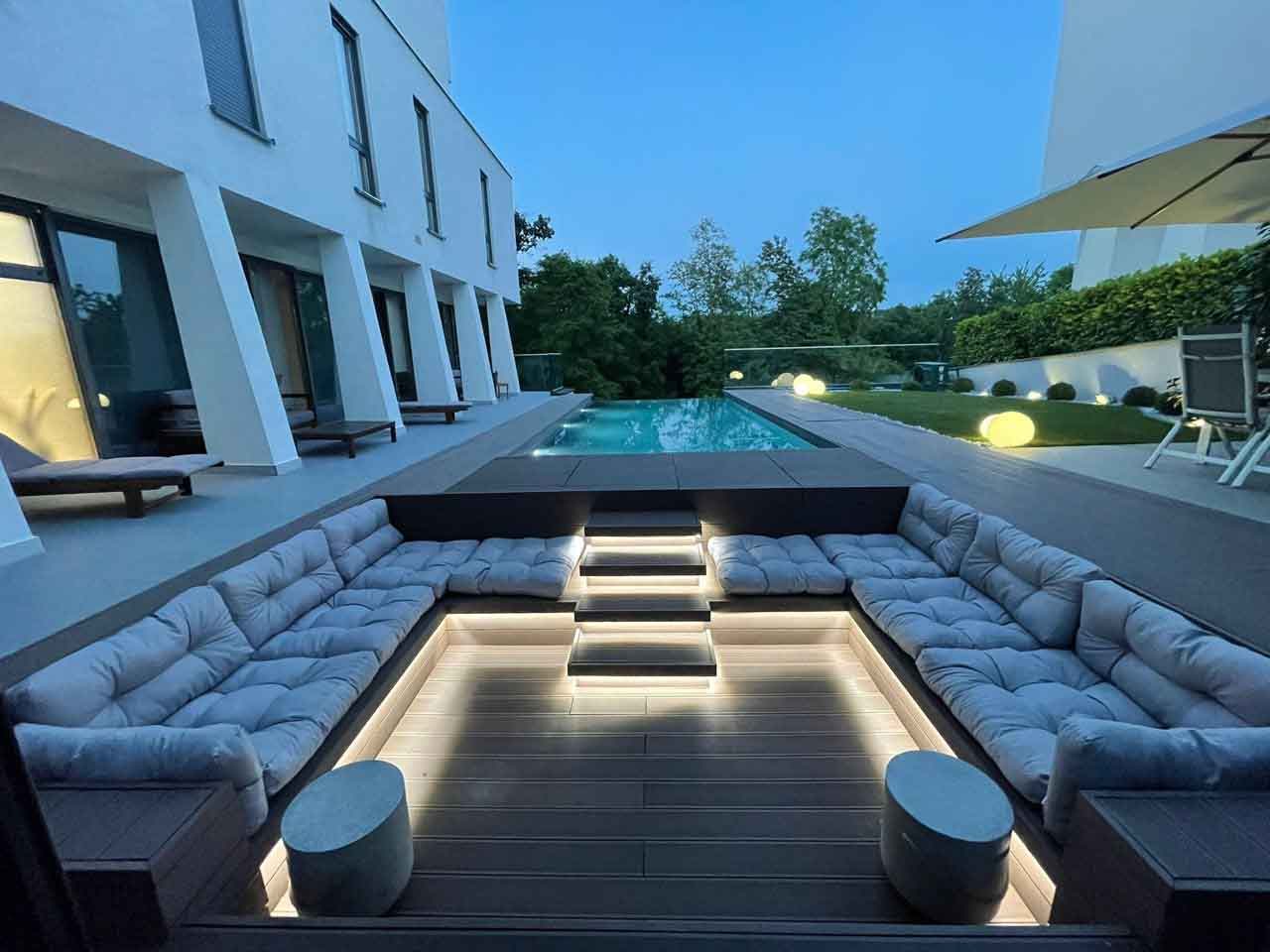 Poolside evening seating area finished with Classic Line composite decking