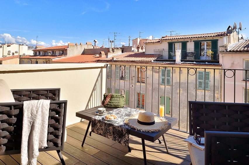 Rooftop terrace breakfast nook with an Italian town view, finished with DURO 3.0 composite decking