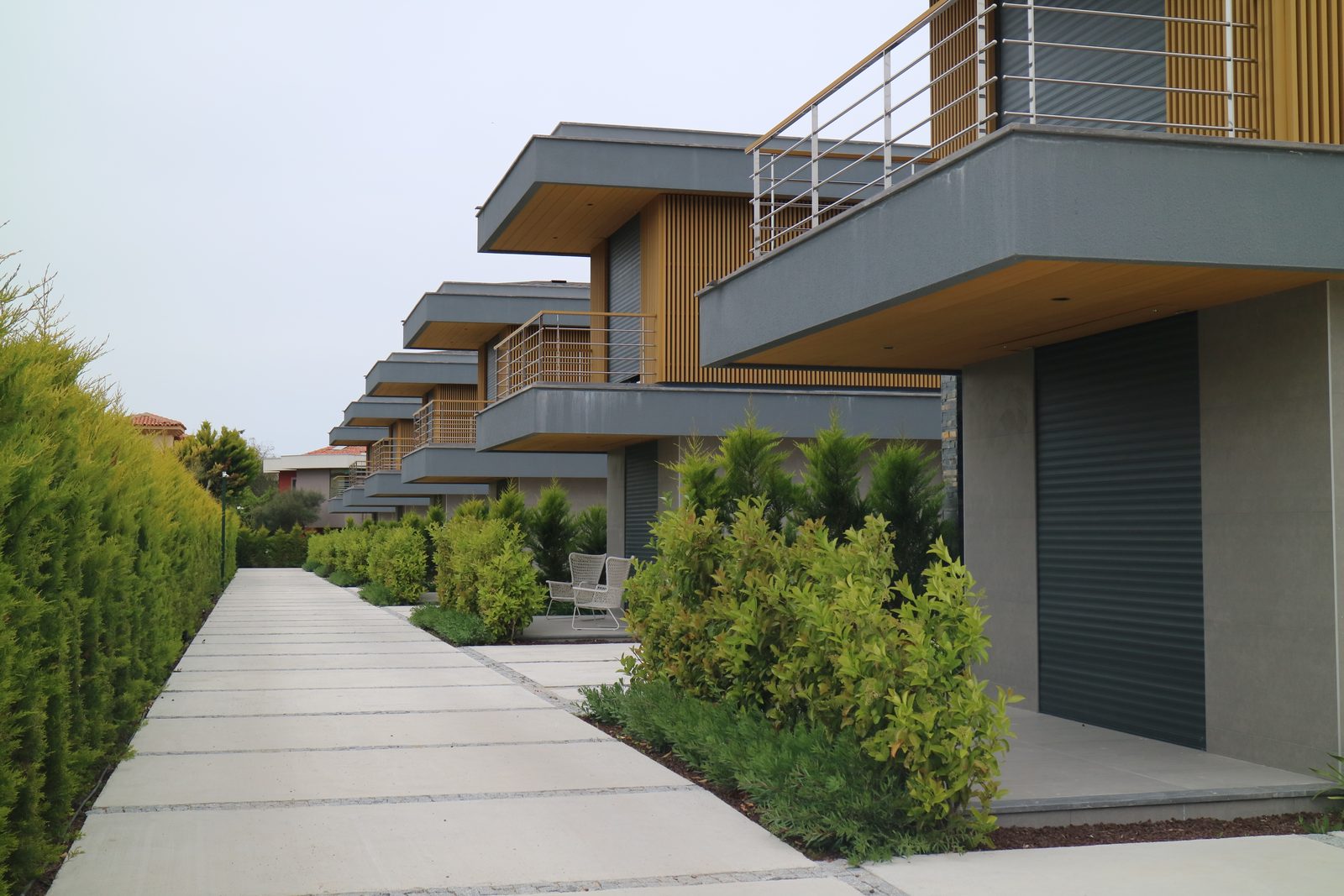 Row of residential balconies clad in wood-look composite wall cladding