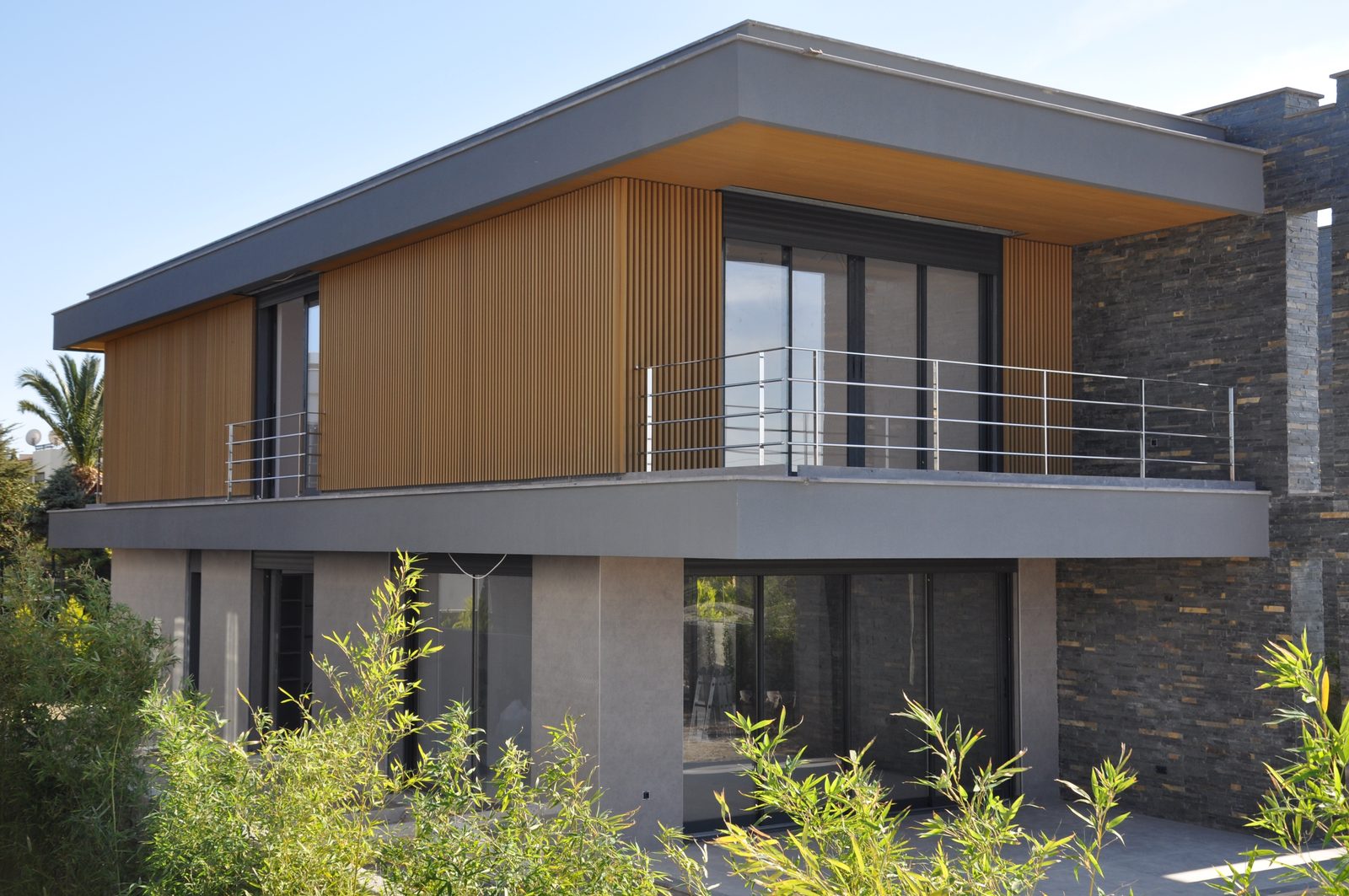 Villa exterior combining stone and composite wall cladding