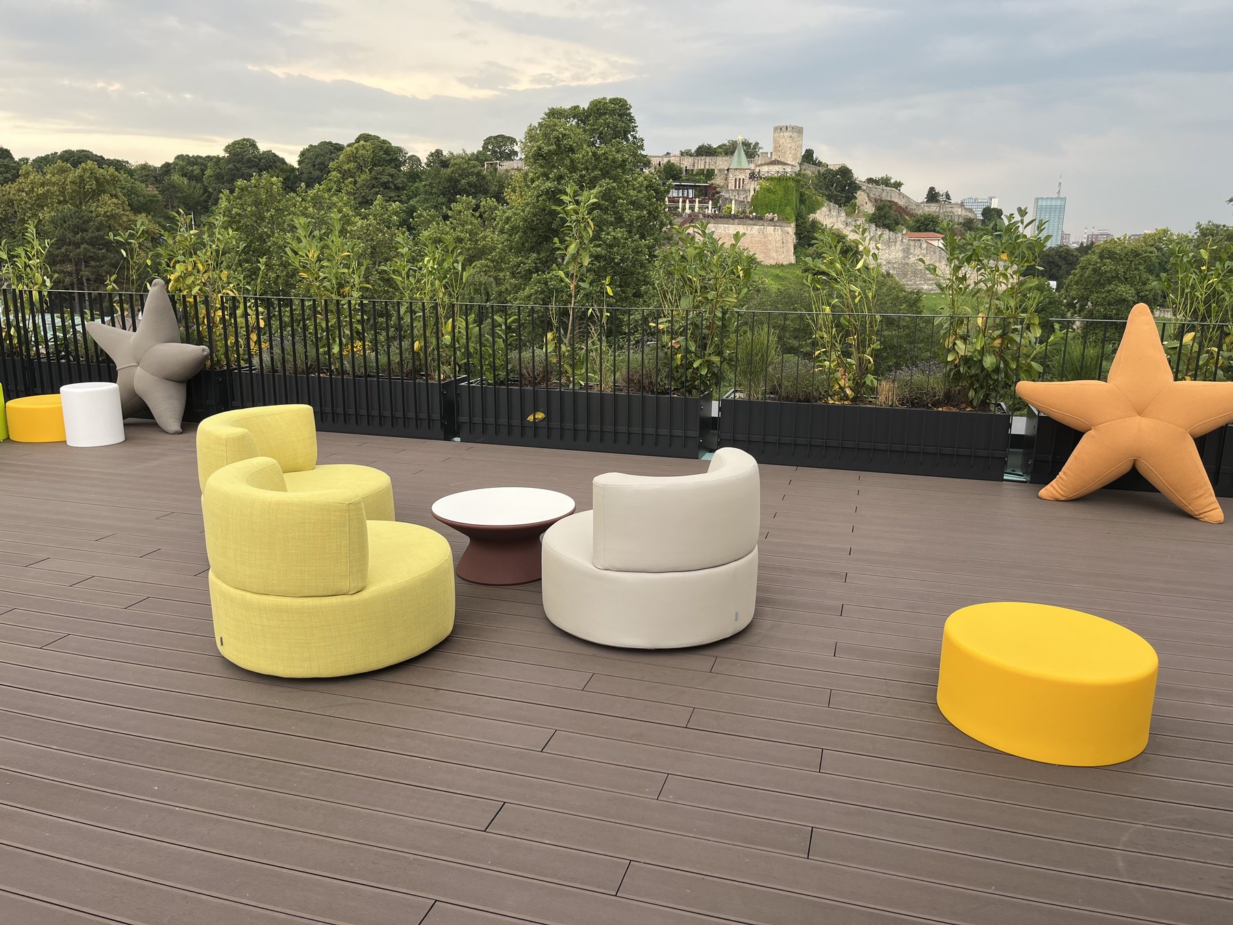 Rooftop terrace lounge area with a castle view, finished in brown composite decking
