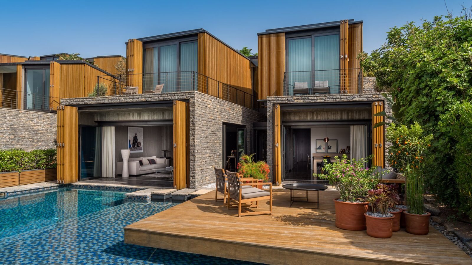 Modern villa and pool clad in wood-look wall cladding